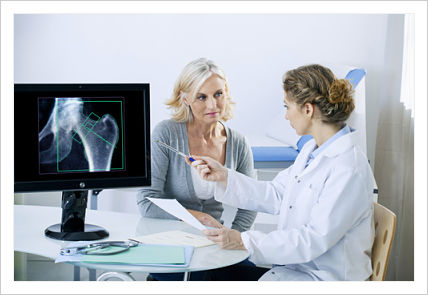This is a picture of a doctor looking over xrays with patient.