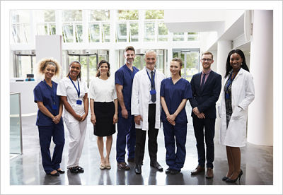 Picture of Physicians and Nurses (Males and Females) standing in a Hospital Lobby