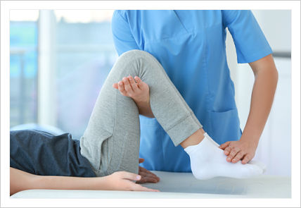 This is a picture of a physical therapist stretching a patient leg.