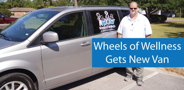 This is a picture of a minivan with a older guy standing next to it, while it says Wheels of wellness gets a new van.