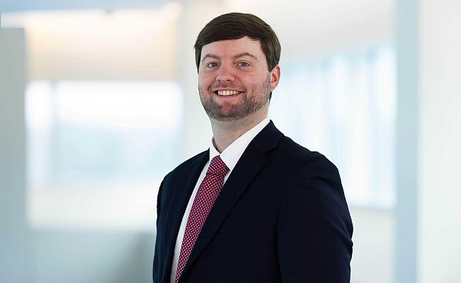 Picture of a male in a suit and tie.