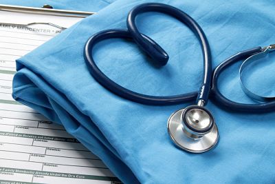 A picture of a stethoscope on the shape of a heart on a blue towel.