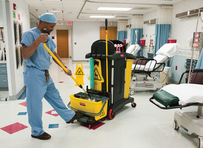Picture of a housekeeper mopping the floor in the ER