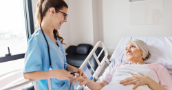 Picture of a Nurse (female) speaking to an elderly patient (female)